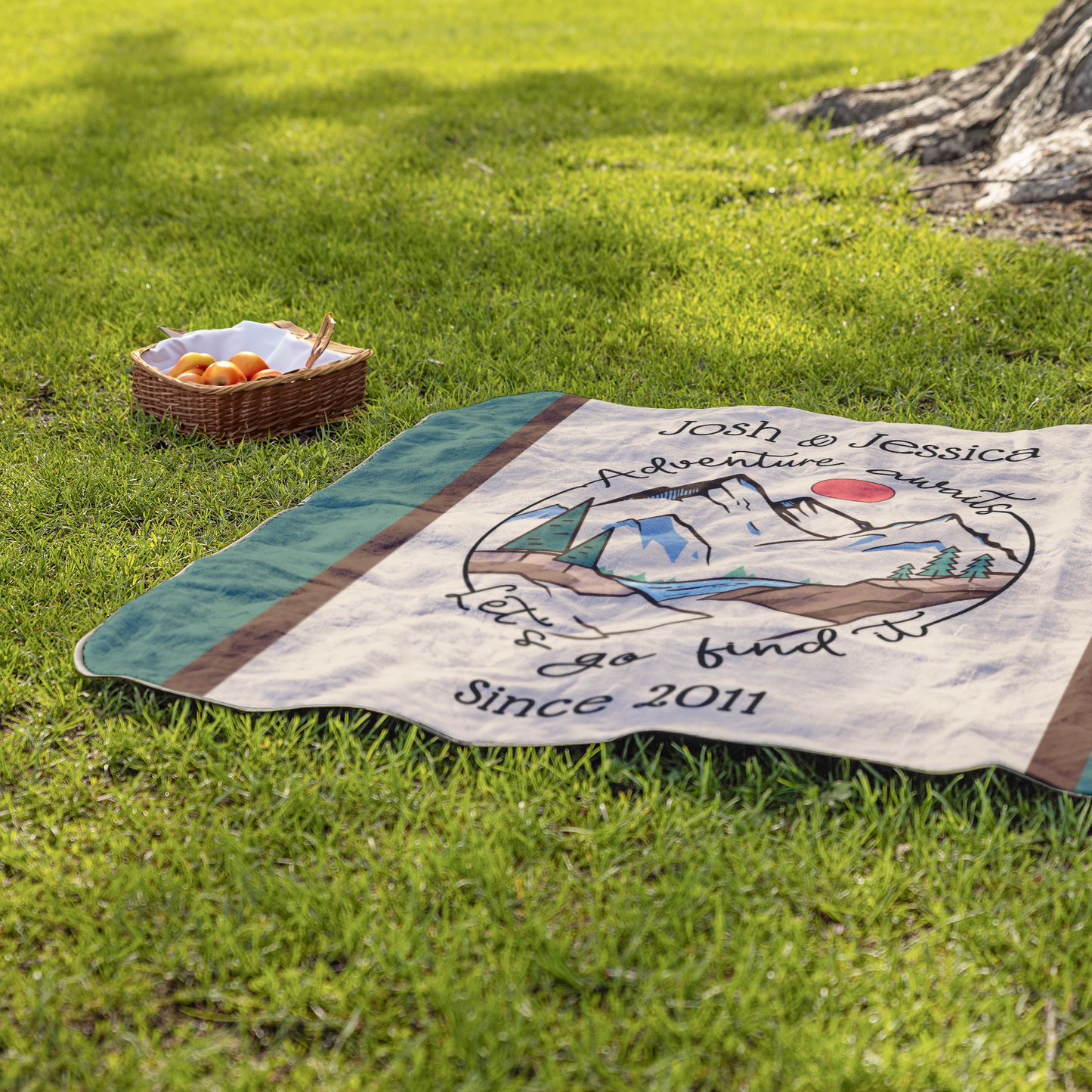 Adventure_Awaits_Blanket_StadiumBlanket_Lifestyle_Grass_H_Mockup.png